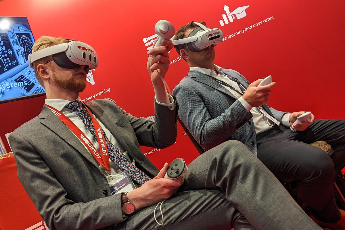 Delegates trying VR training headsets at an exhibitor stand